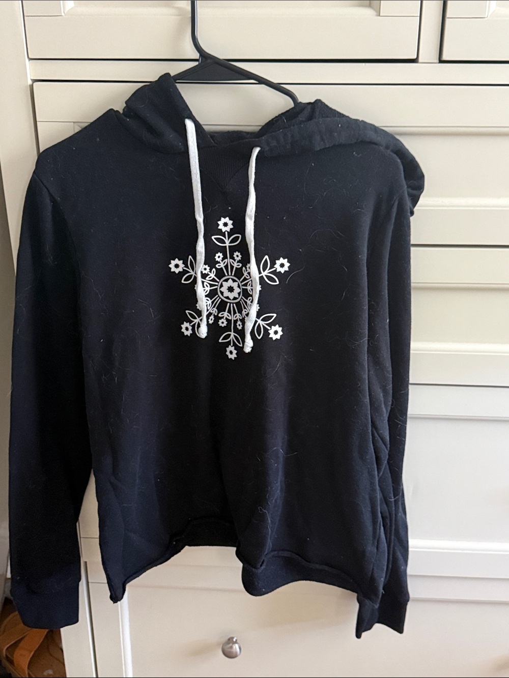 Club Pilates Black Cropped Hoodie with White Floral / snowflake logo
